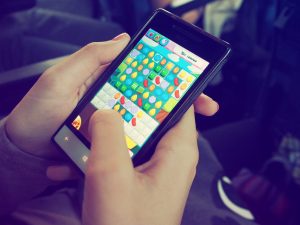 person playing candy crush on nokia smartphone